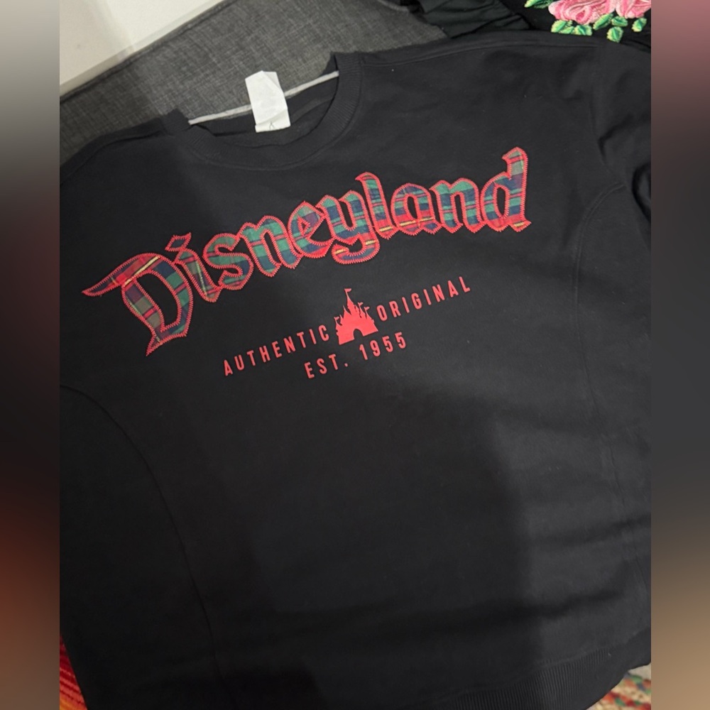 NEW- Disneyland Black Sweatshirt with Red, Blue and Green Plaid Lettering